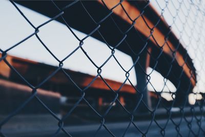 Close-up of chainlink fence against sky