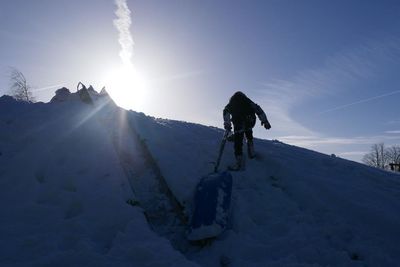 Full length of people on mountain against sky