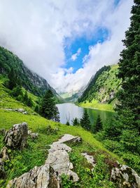 Scenic view of landscape against sky and mountainlake