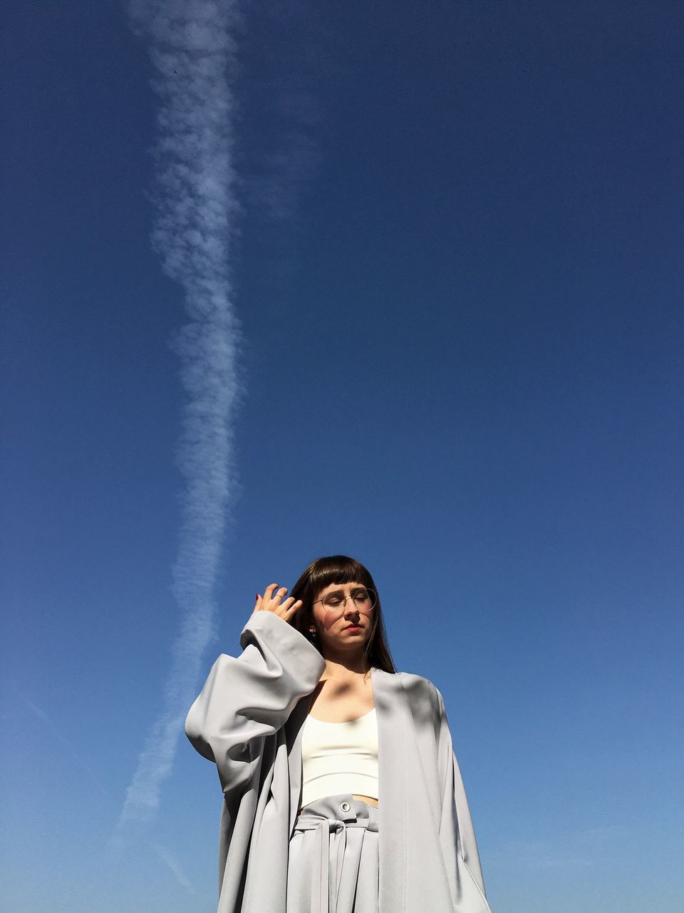 blue, sky, one person, low angle view, copy space, adult, nature, standing, young adult, looking, looking up, happiness, cloud, emotion, smiling, clothing, waist up, front view, portrait, day, women, religion, person, outdoors, spirituality, clear sky, white, sunny, belief