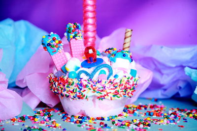 Close-up of birthday cupcake by crumpled paper