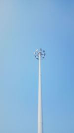 Low angle view of communications tower against blue sky