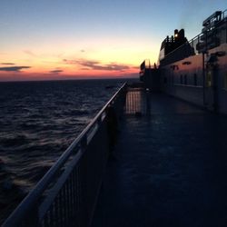 Pier on sea at sunset