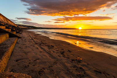 Scenic view of beach against sky during sunset