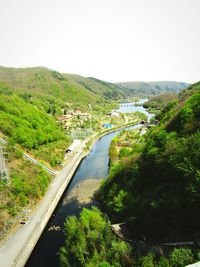 High angle view of road by river against clear sky