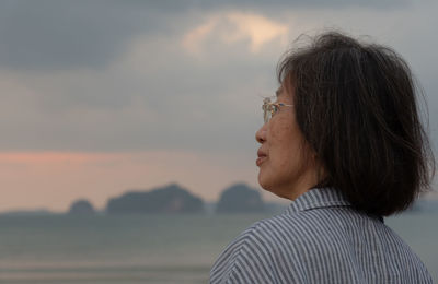 Portrait of woman looking at sunset