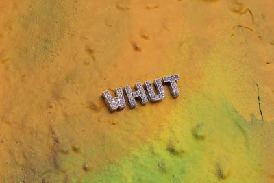 High angle view of text on rusty metal