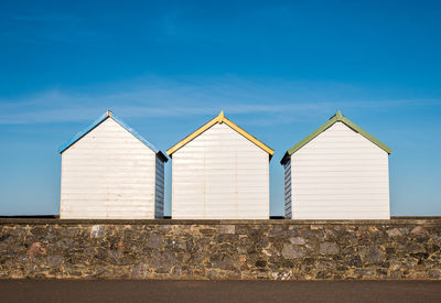 Low angle view of beach huts against sky