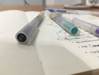 Close-up of pens over text on paper