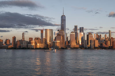 Modern buildings in city against cloudy sky