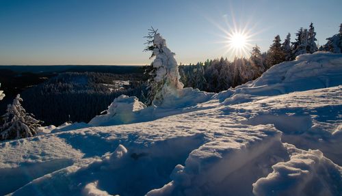 Scenic view of snow covered landscape against sky