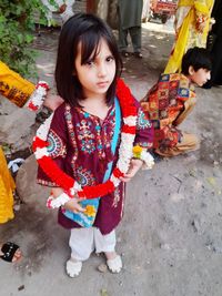 Full length of woman holding camera