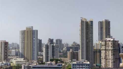 Modern buildings in city against clear sky