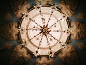 Low angle view of illuminated lighting equipment hanging