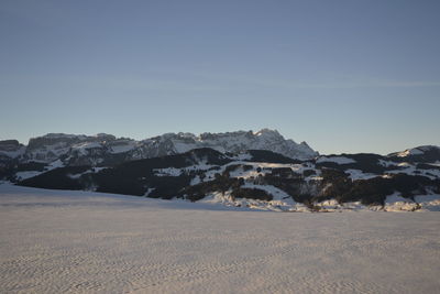 Scenic view of snowcapped mountains against clear sky