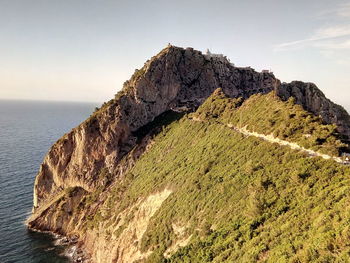 Scenic view of rock formation in sea against sky