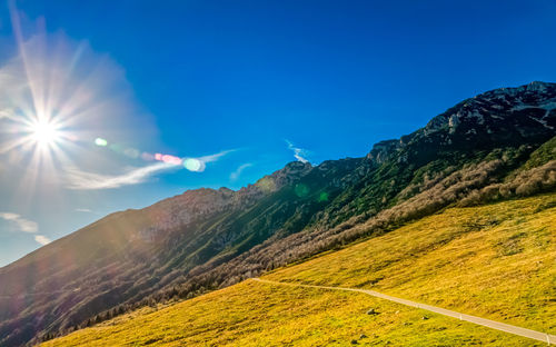 Scenic view of mountains against blue sky