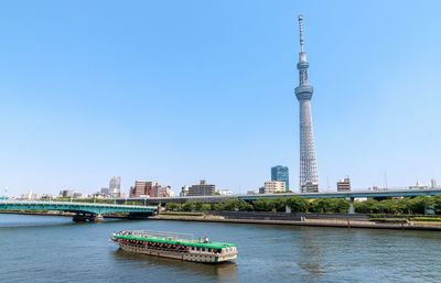 Ship in city against clear sky