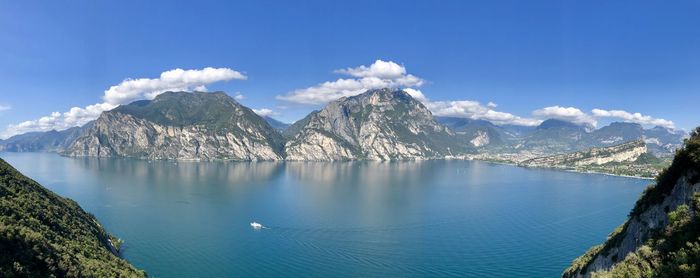 Panoramic view of lake and mountains against blue sky