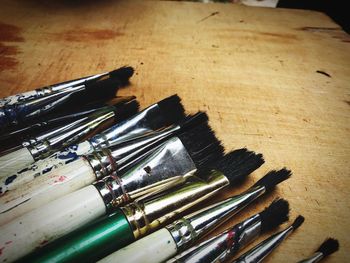 Close-up of paint brushes on table