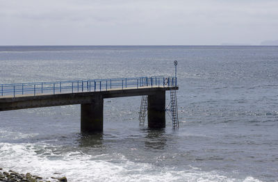 Pier over sea against sky