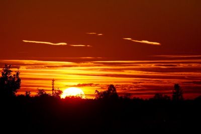 Silhouette landscape against scenic sky