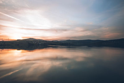 Scenic view of lake against sky during sunset