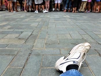 Low section of people standing on zebra crossing