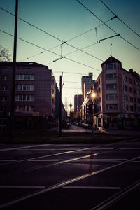 View of city street and buildings against sky