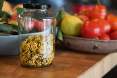 Close-up of fruits in glass jar on table