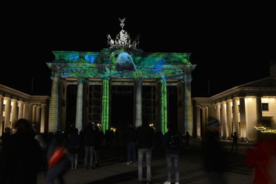 Group of people in front of building at night