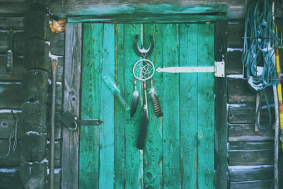 Close-up of padlocks hanging on closed door