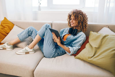 Young woman using digital tablet at home