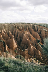 Rock formation on land against sky