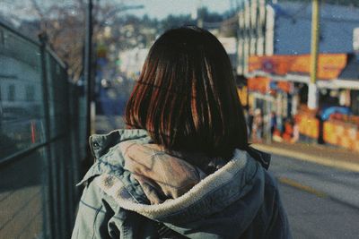 Rear view of woman in hood standing outdoors