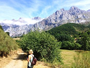 Rear view of people on mountain against sky