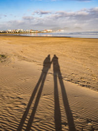 Shadow of people on beach