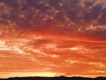 Low angle view of dramatic sky during sunset