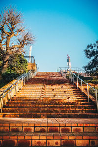 Steps against clear blue sky