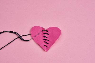 Close-up of heart shape on pink background