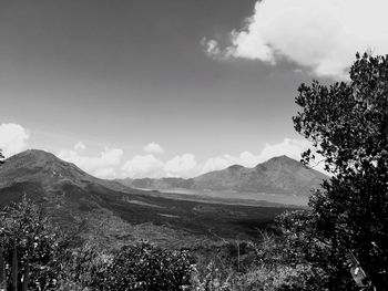 View of countryside landscape against mountain range