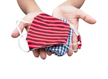 Midsection of woman holding umbrella against white background