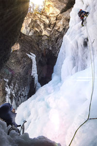 High angle view of man on rock during winter