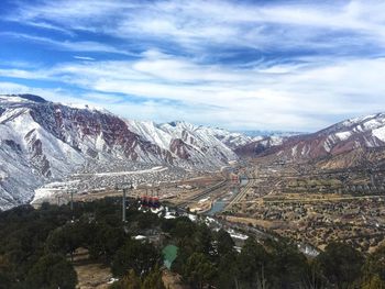 High angle view of snowcapped mountains against sky