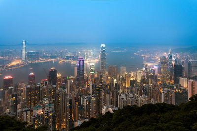 Illuminated cityscape against sky at night