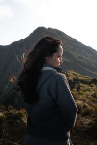 Young woman portrait in the mountains with sunlight