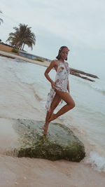 Full length of woman standing on beach