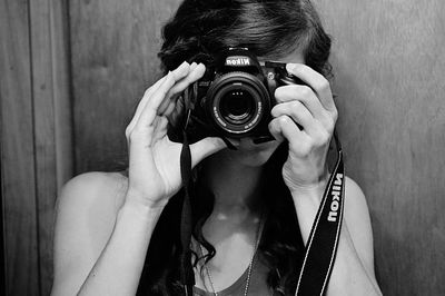 Close-up of woman photographing through smart phone