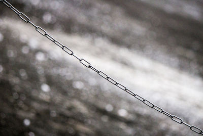 Close-up of chain against blurred background