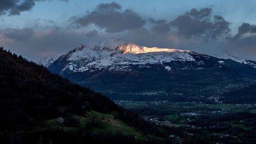 Scenic view of snowcapped mountains against sky at night